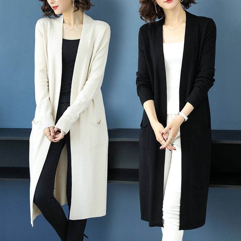 Calf-length trench coat paired with a chic knit cardigan