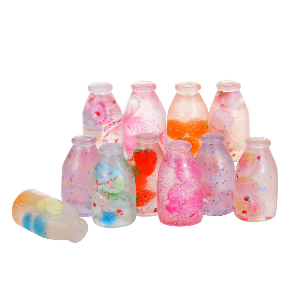 Jouet de pression de bouteille de soda avec la sable