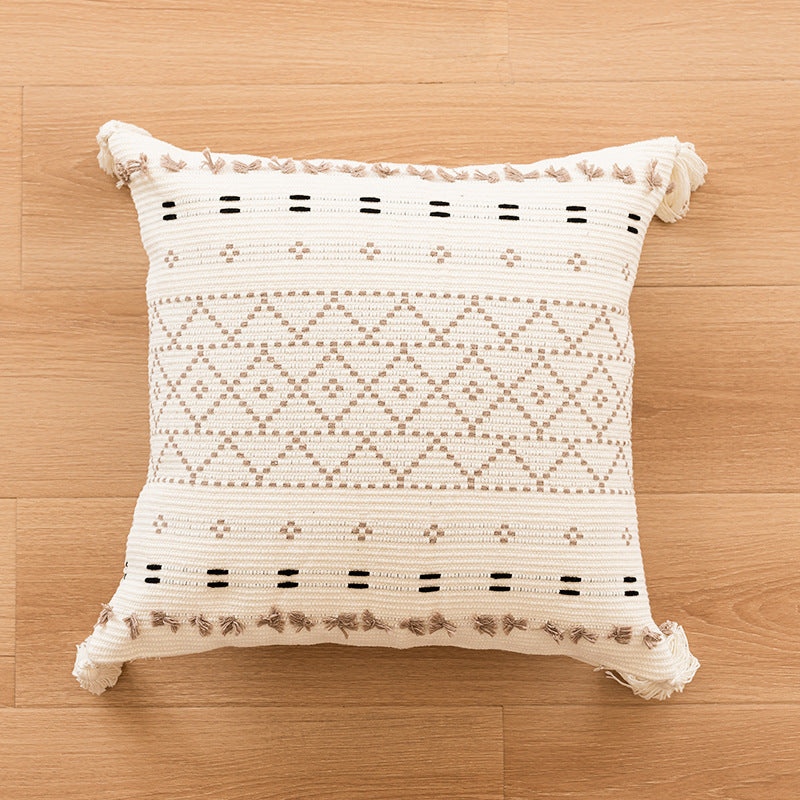 Canapé simple avec un coussin en tassel et des housses d'oreiller