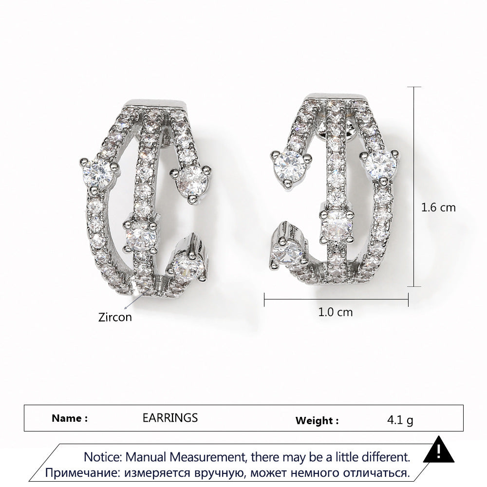 Boucles d'oreilles CZ Huggie entremêlées femmes