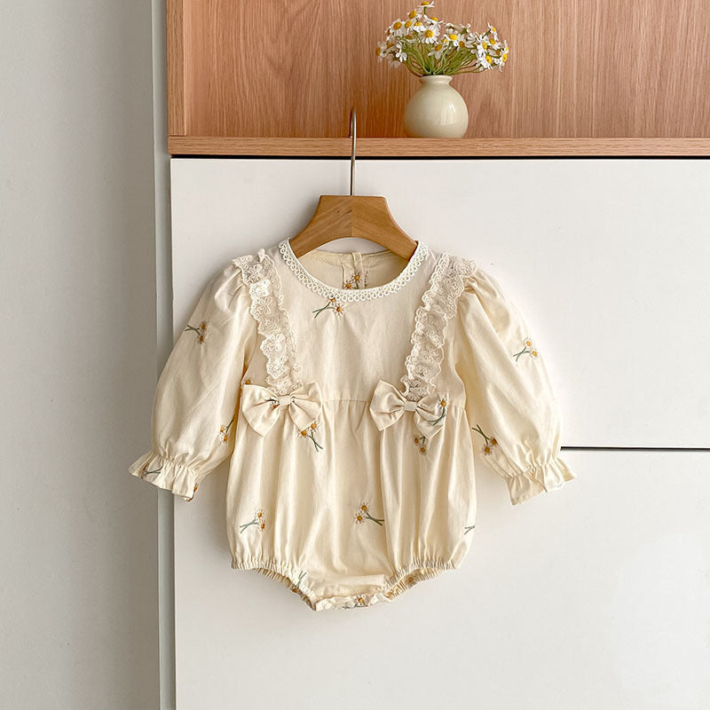 Baby bodysuit with long sleeves, bow, and embroidery