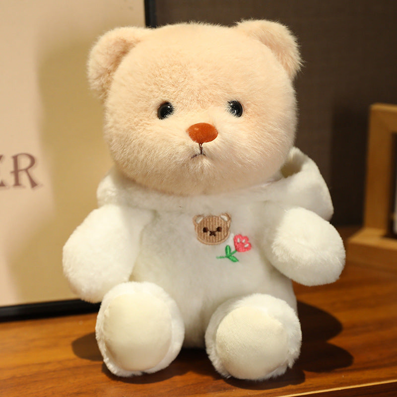Logo de tête d'ours mignon se transforme en une poupée en peluche douce et adorable de la série Ours