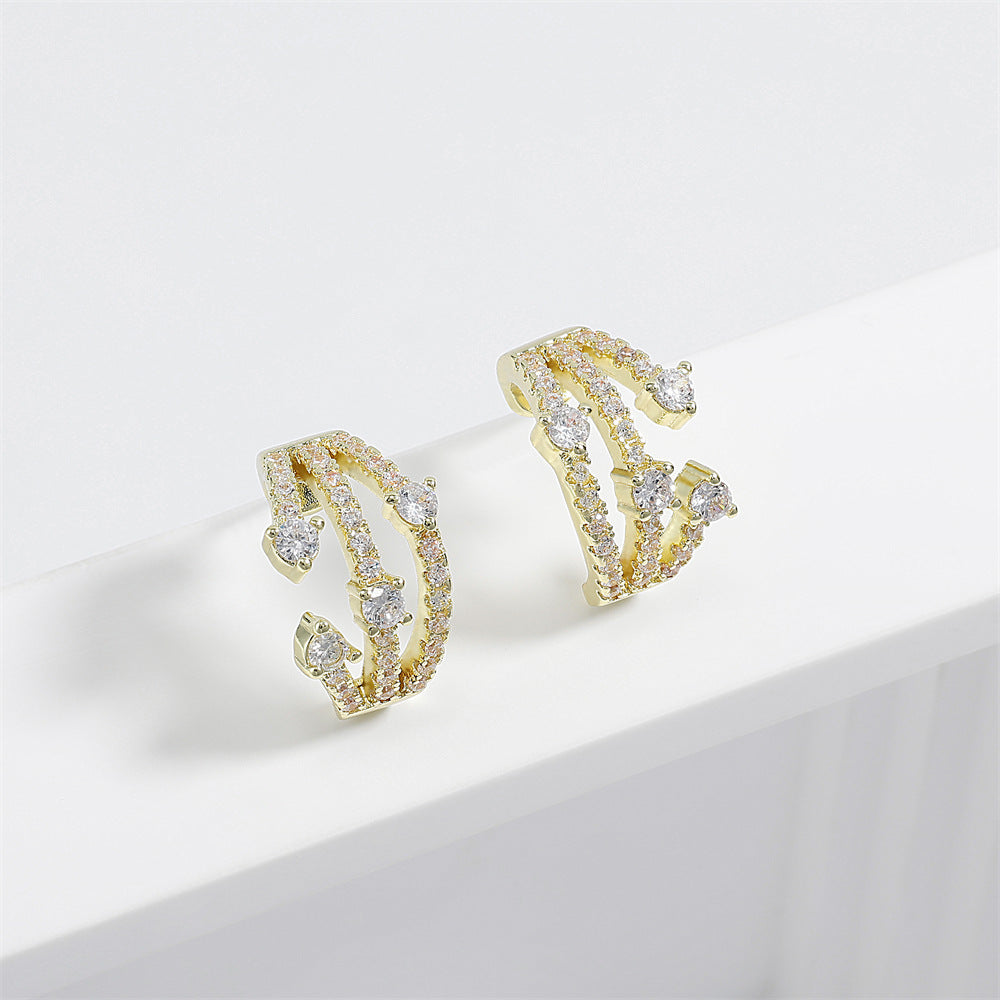 Boucles d'oreilles CZ Huggie entremêlées femmes