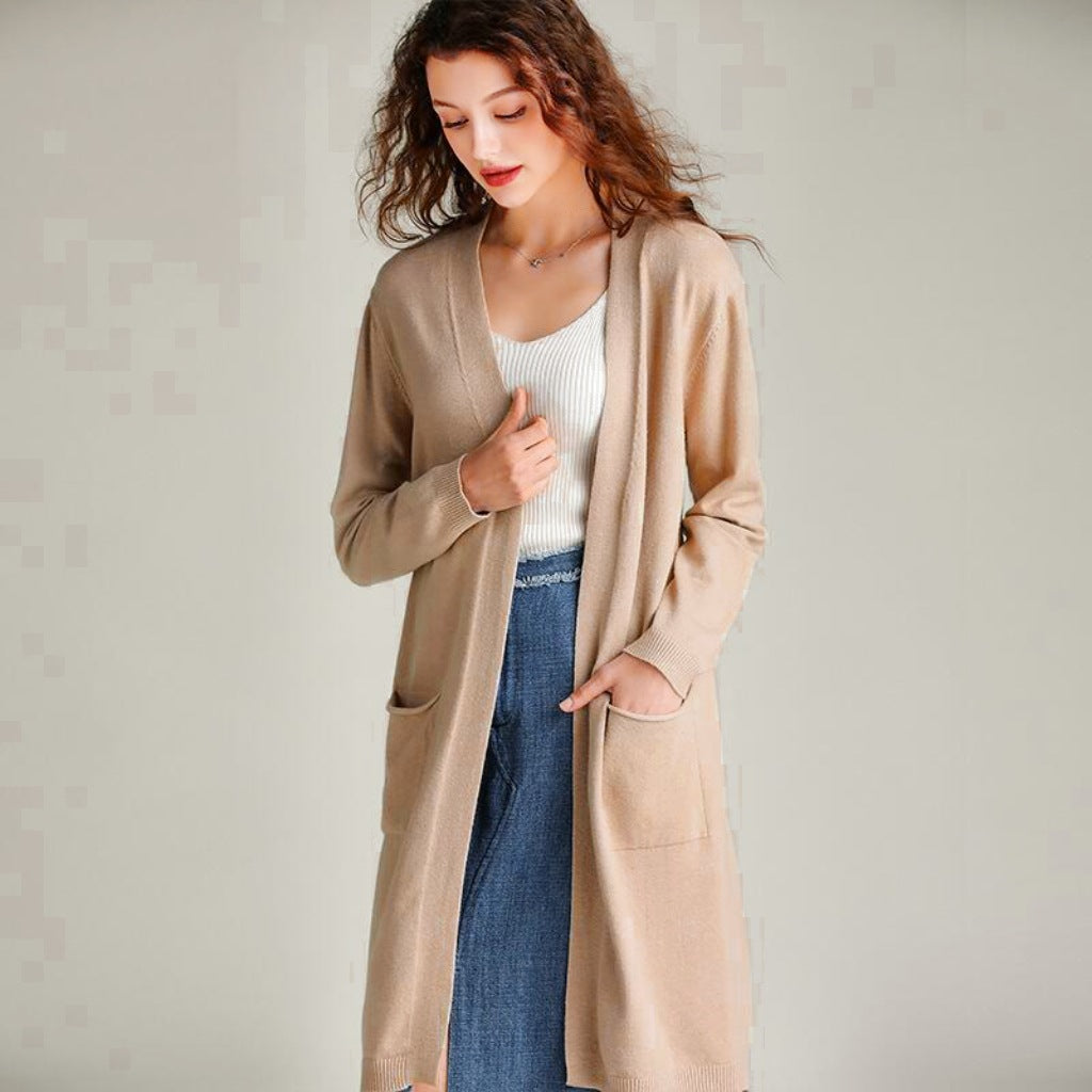 Calf-length trench coat paired with a chic knit cardigan