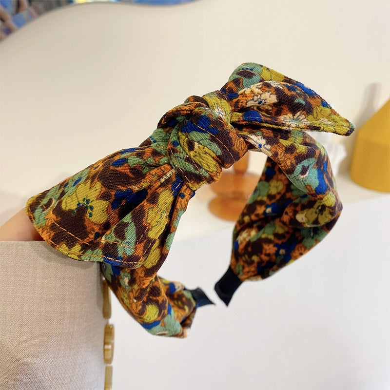 Simple bande de cheveux de tissu large bordé avec un motif imprimé et un noeud lié