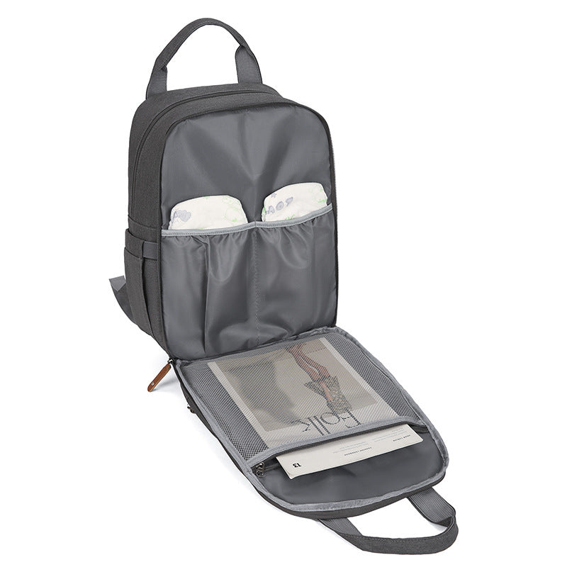 Sac à couches multifonctions avec un tampon à langer bébé et un compartiment chauffant