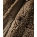 Manteau court doublé en cuir et en fourrure combiné avec du lambswool
