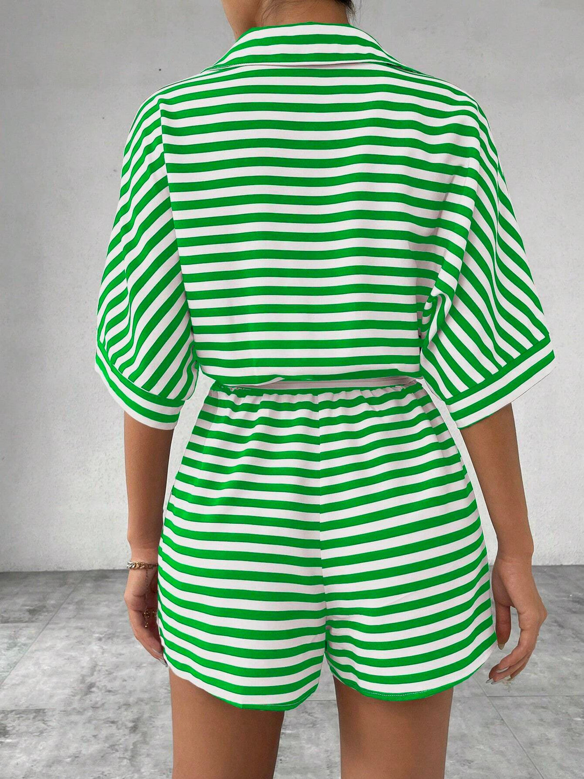 Striped summer jumpsuit featuring a lapel collar, button-front cardigan style