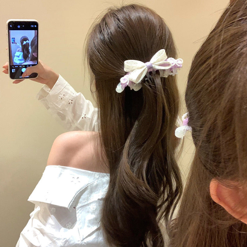 Coiffure de tissu à la banane de la Bow Florale
