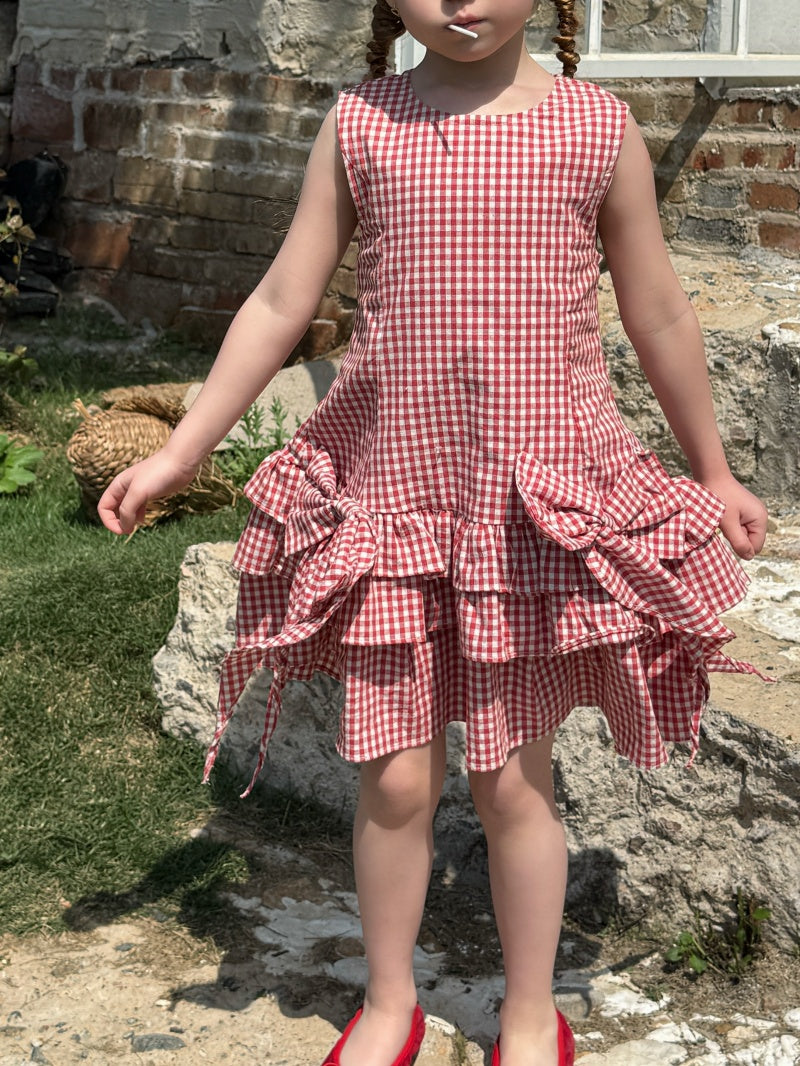 Robe à carreaux sans manches de fille avec arc rouge et jupe à manches multiples