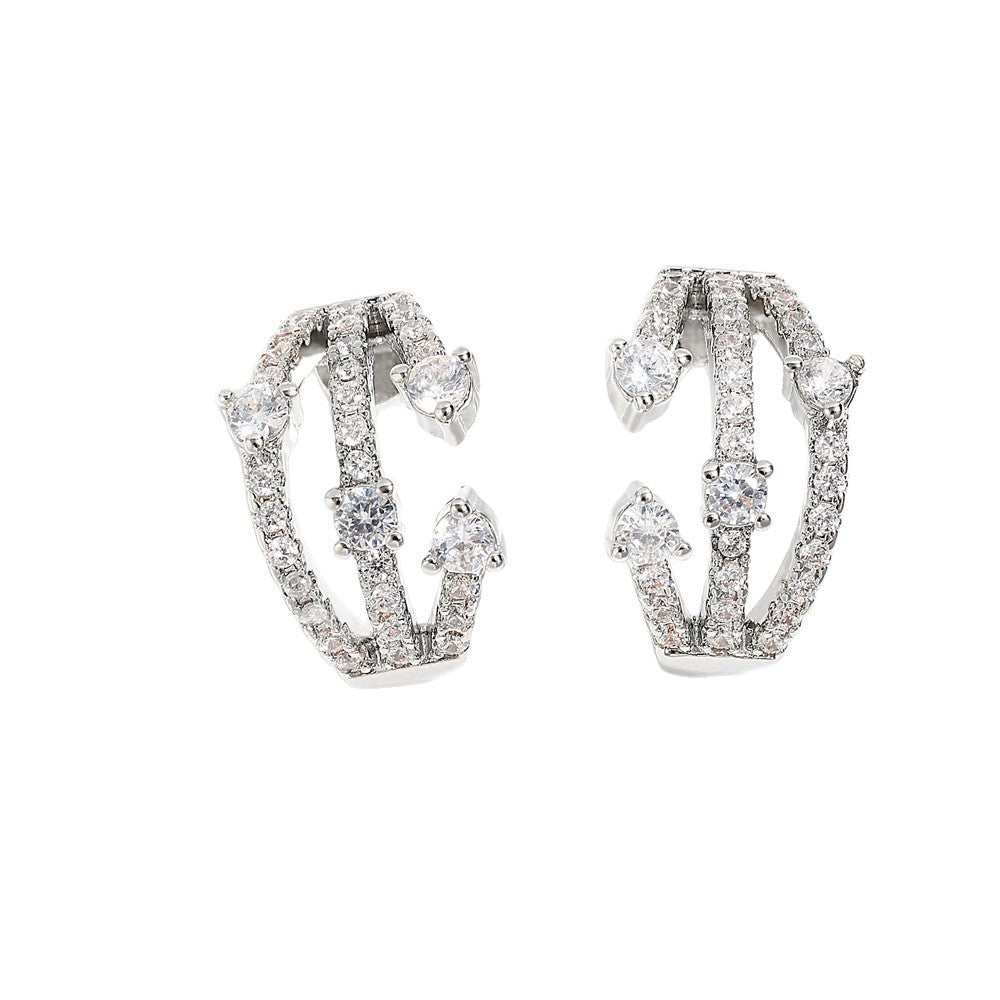 Boucles d'oreilles CZ Huggie entremêlées femmes