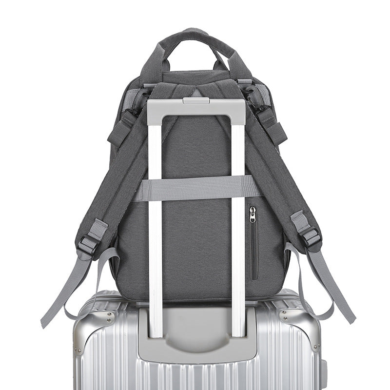 Sac à couches multifonctions avec un tampon à langer bébé et un compartiment chauffant