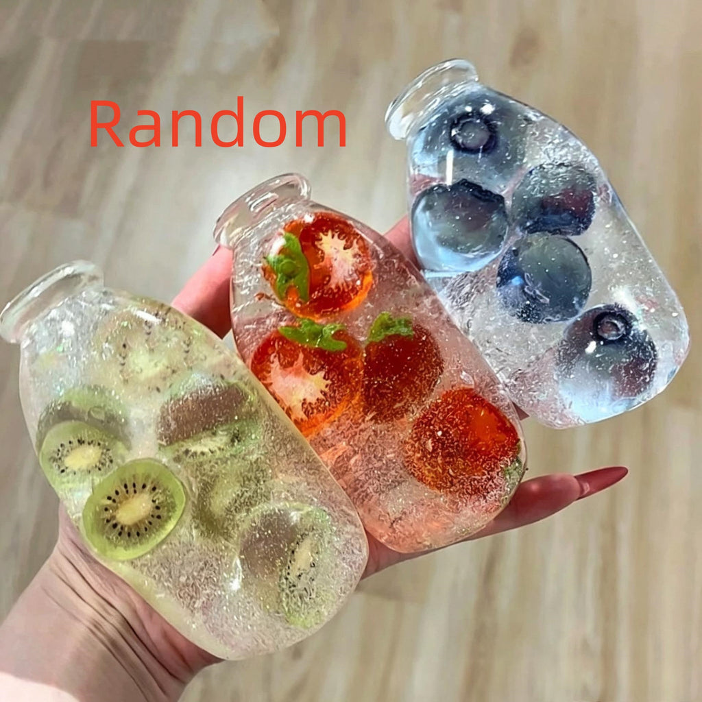 Jouet de pression de bouteille de soda avec la sable