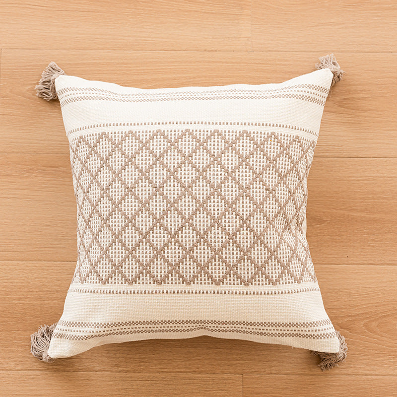 Canapé simple avec un coussin en tassel et des housses d'oreiller