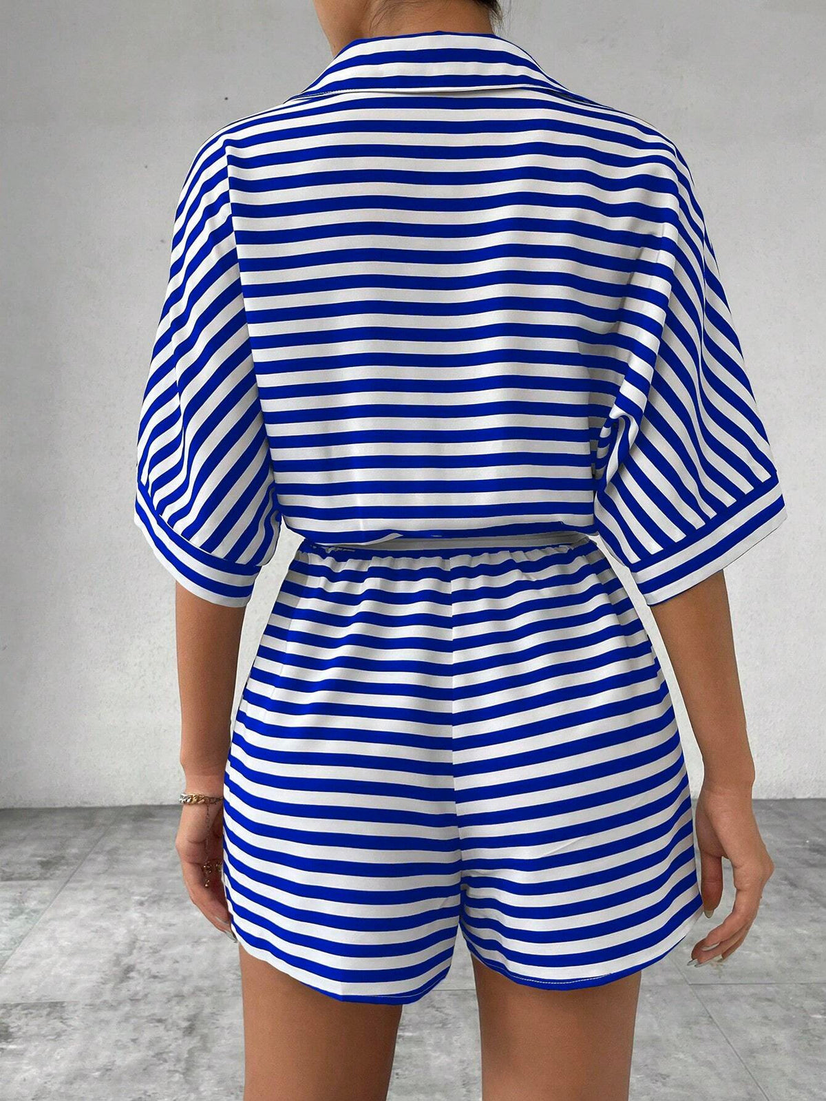 Striped summer jumpsuit featuring a lapel collar, button-front cardigan style