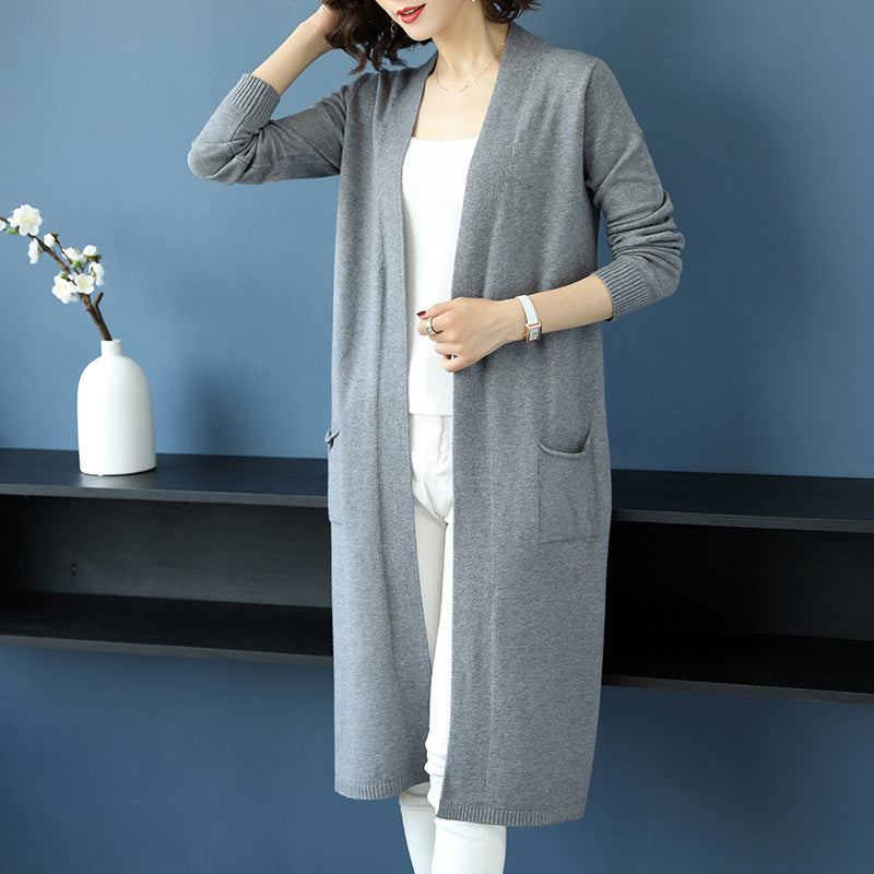 Calf-length trench coat paired with a chic knit cardigan