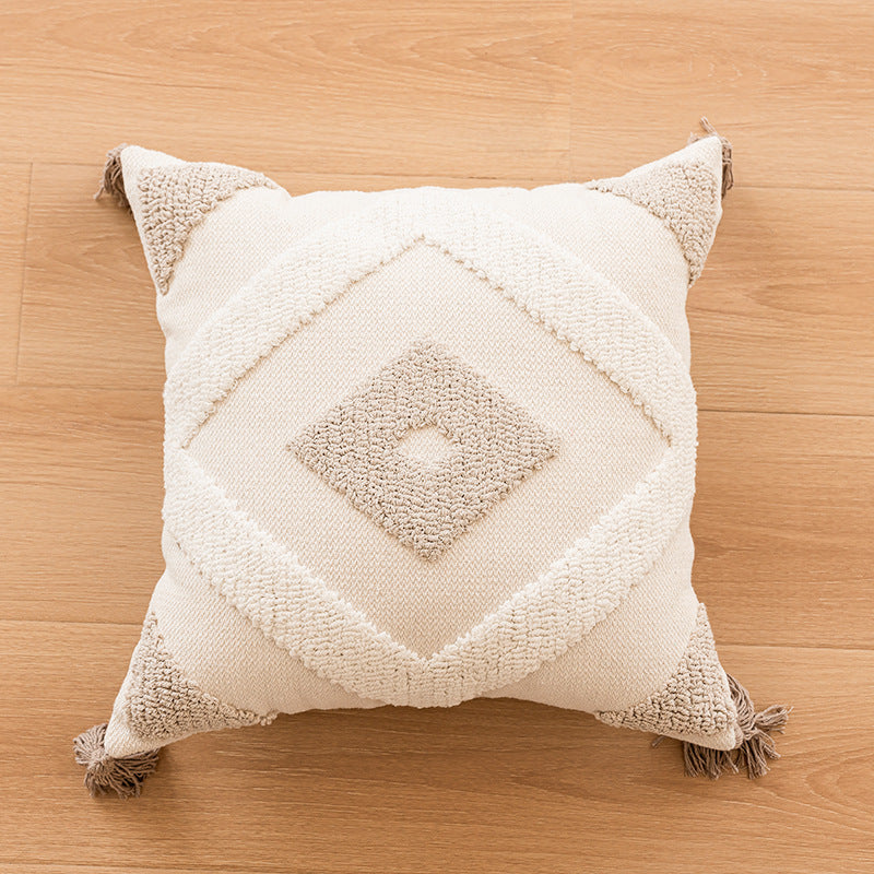 Canapé simple avec un coussin en tassel et des housses d'oreiller